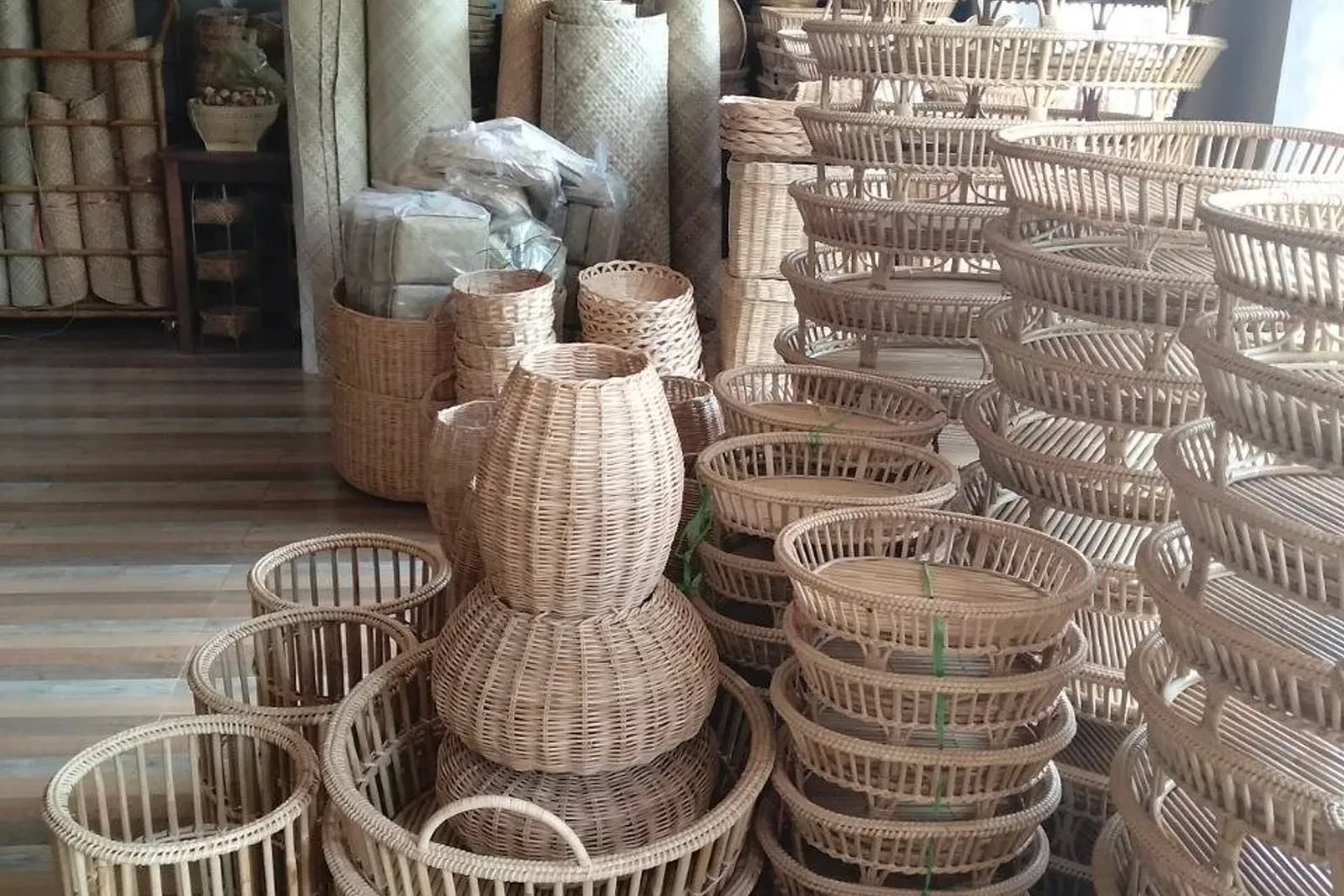 Stacked rattan baskets and round woven trays in the shop
